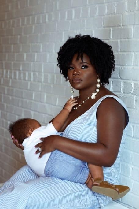 A mother holding her baby at a PROaid Africa maternal health workshop